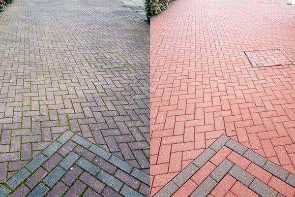 Cabro paving half pressure-washed, showing the clean red finish against the dirty surface
