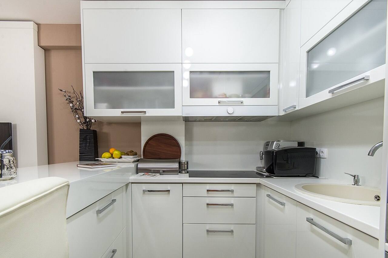 A clean, modern kitchen with white cabinetry